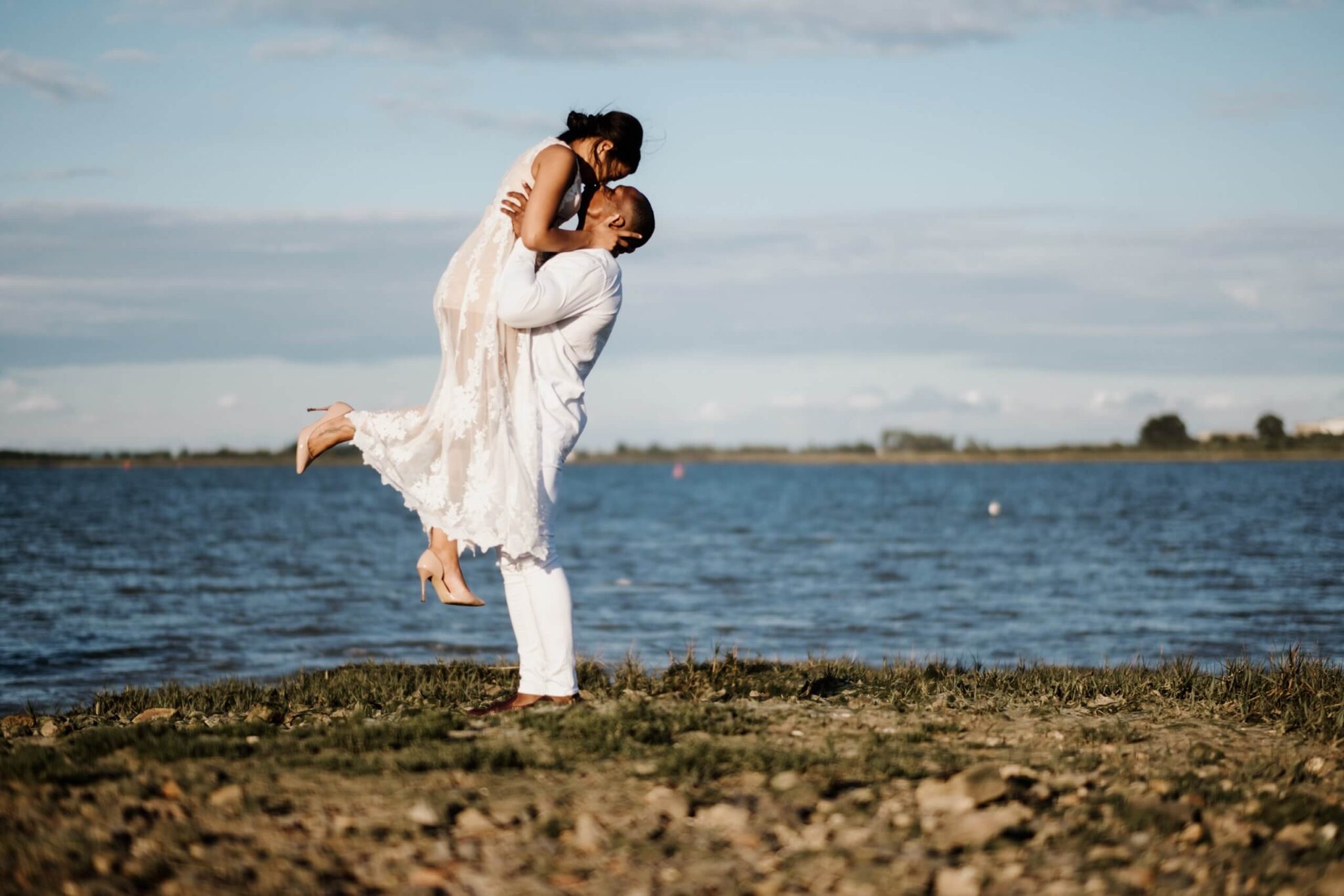 Engagement Shoot, man lifting woman up and they are kissing. | Kent Wedding Photographer